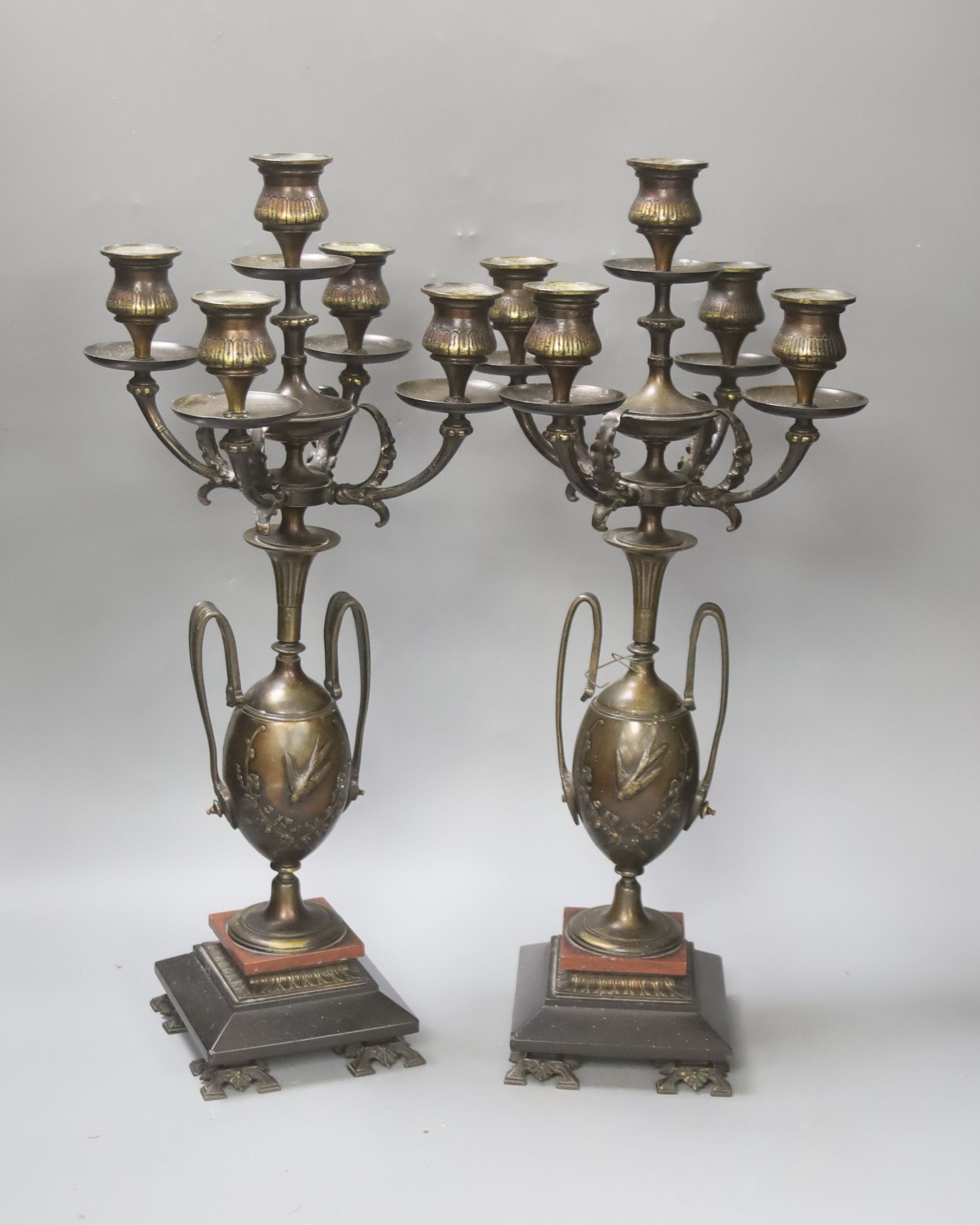 A pair of Aesthetic period bronze five light candelabra with twin handled vase supports on black and rouge marble base, height 48cm